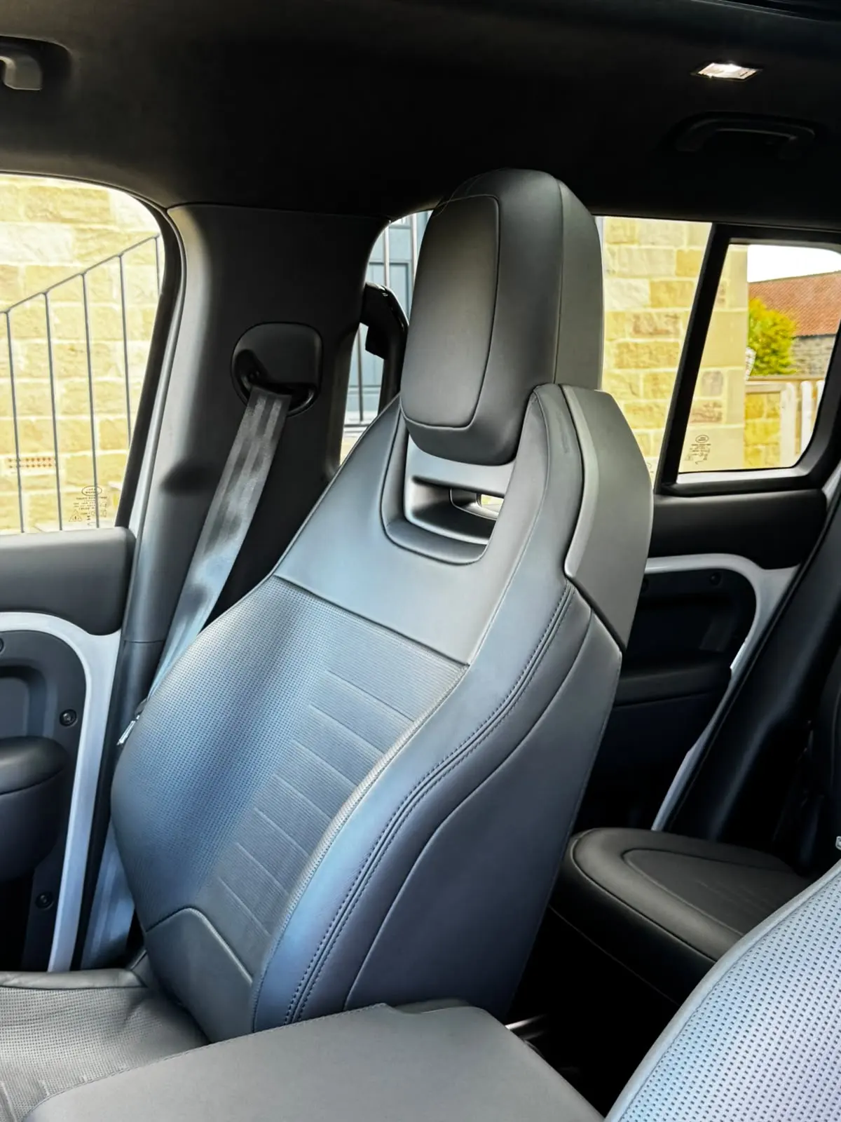 Clean grey leather seat inside a Land Rover Defender after a monthly maintenance visit