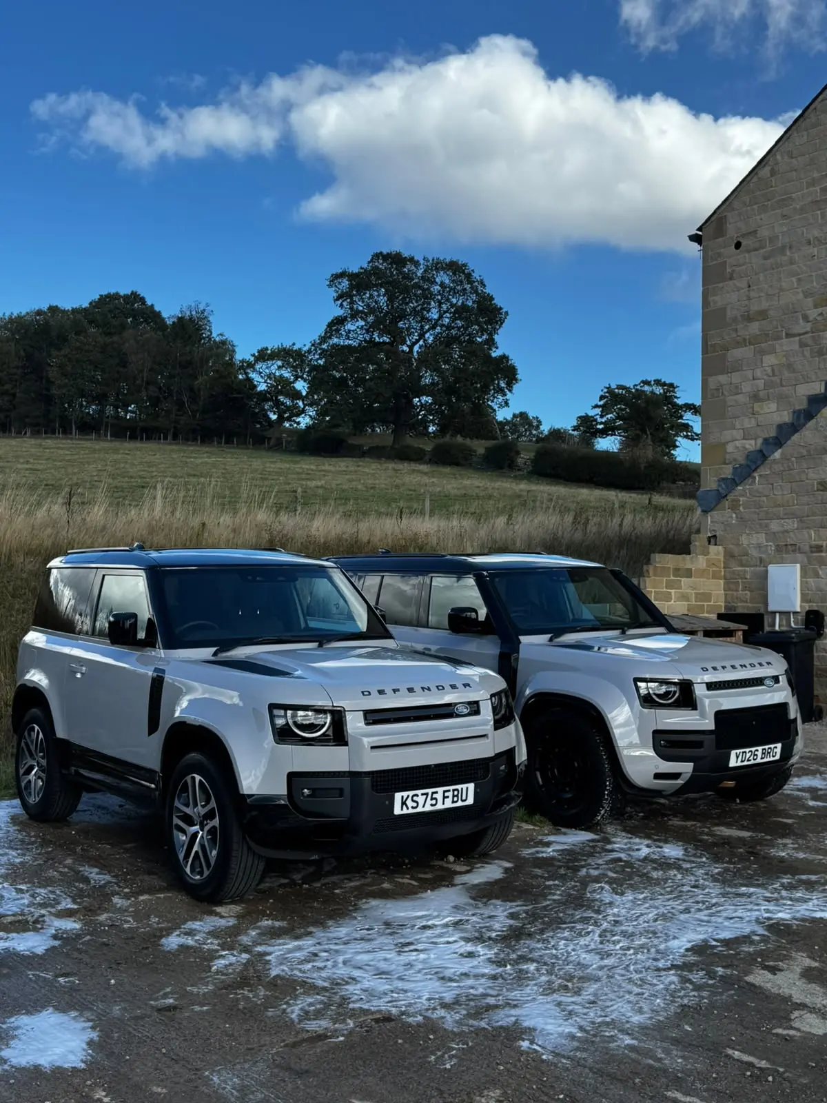 Land Rover Defender 90 and Defender 110 side by side after a monthly maintenance visit in Harrogate