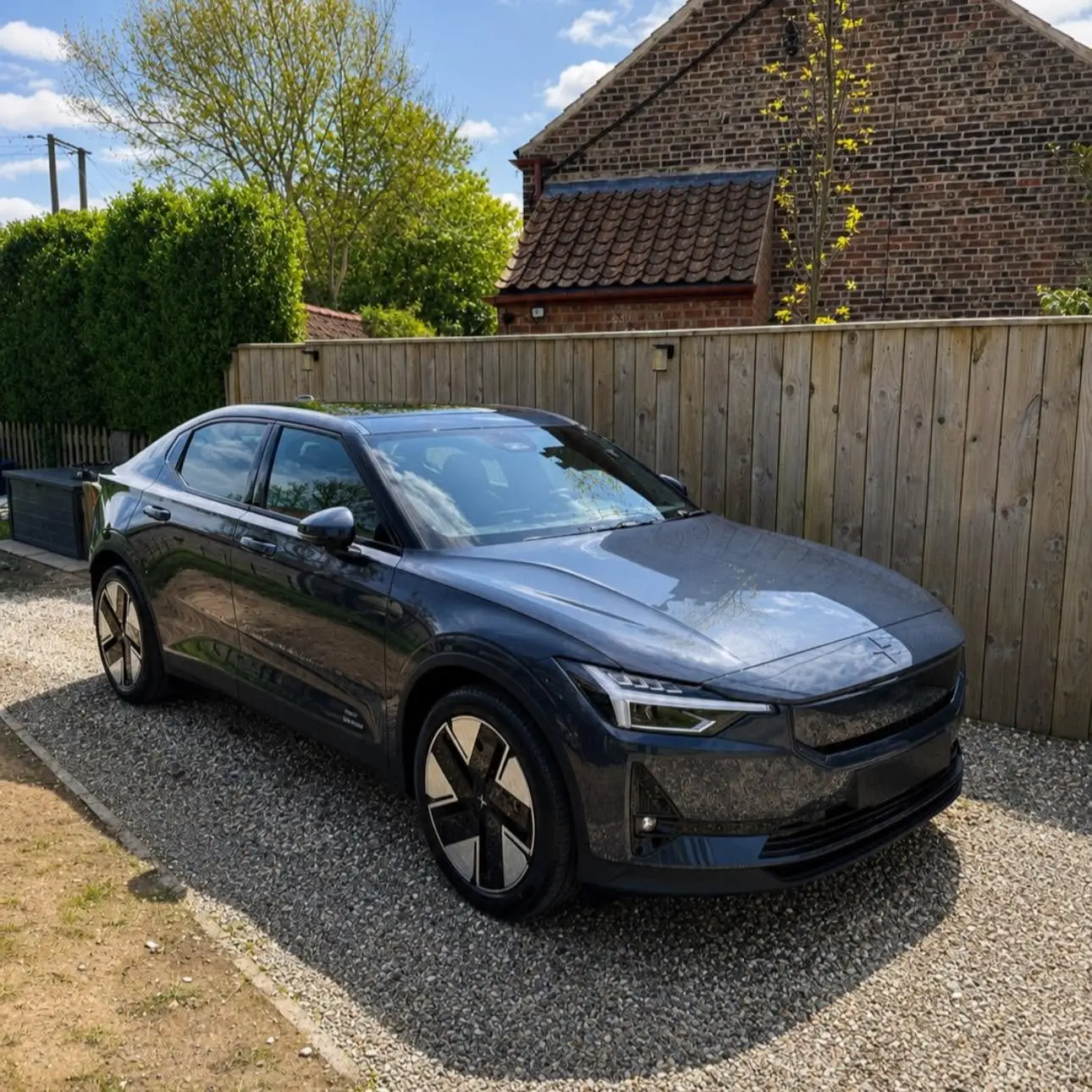 Grey Polestar 2 on a gravel drive