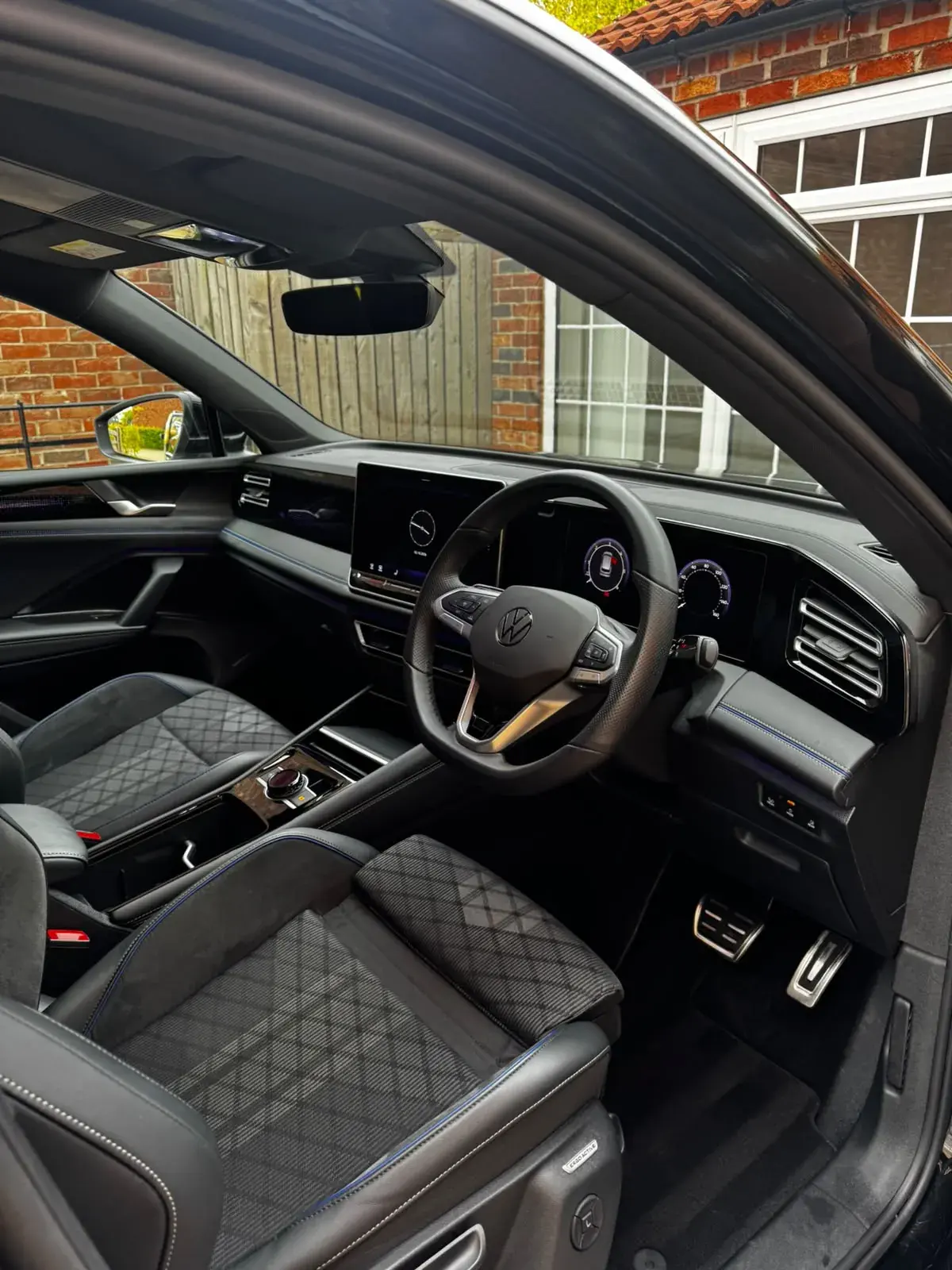 Spotless front cabin of a Volkswagen Tiguan: clean mats, seats, dash and pedals
